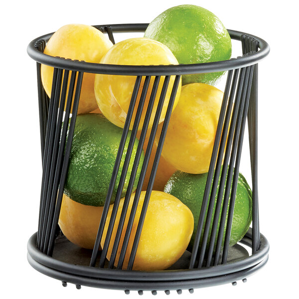 A Cal-Mil black wire basket with a lime and a lemon inside.