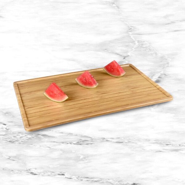 A slice of watermelon on an Elite Global Solutions faux bamboo melamine serving board.