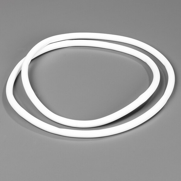 A white rubber ring with a round tube on a gray surface.