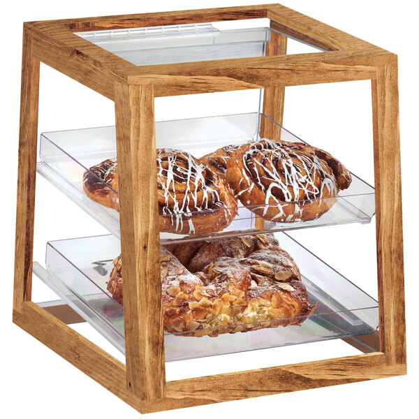 A Cal-Mil wooden display case with two tiers of pastries on a glass tray.