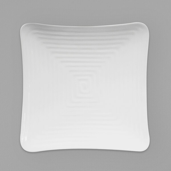 A white square plate with a spiral pattern.