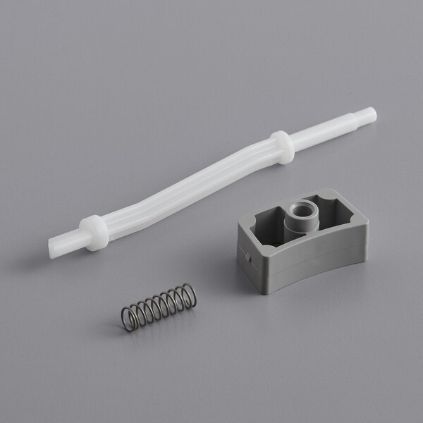 A grey plastic and metal spring with a screw.