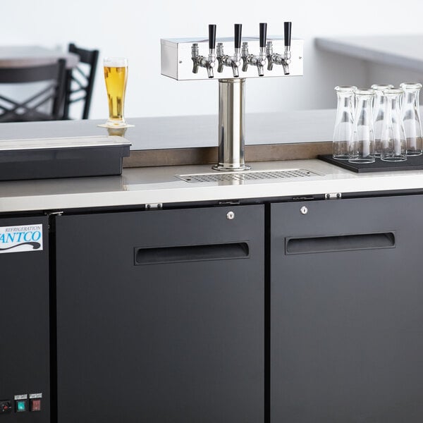 An Avantco black beer dispenser with four taps on a counter.