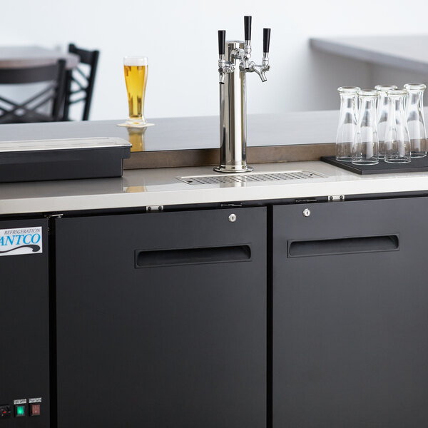 An Avantco black beer dispenser on a counter with two beer taps.