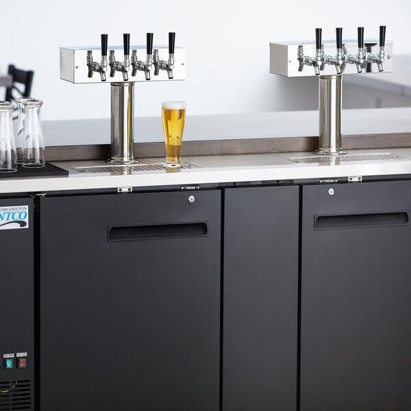 An Avantco UDD-3-HC beer dispenser with two beer taps on a counter.