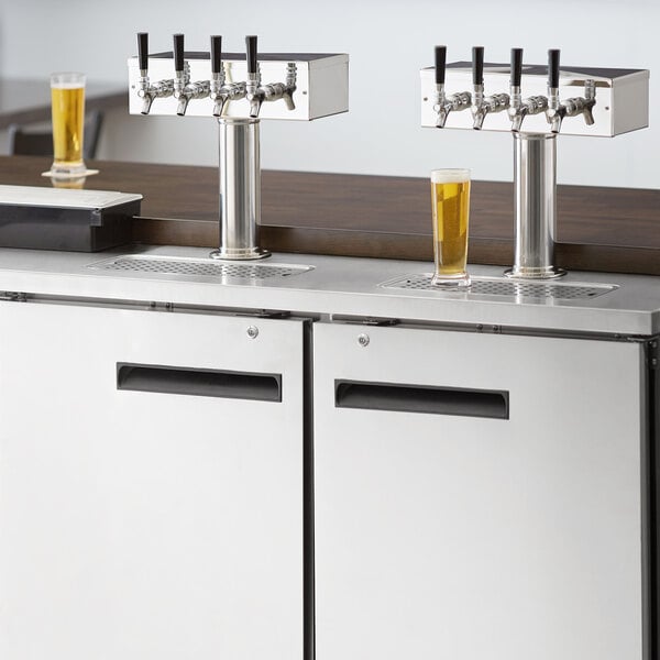 A stainless steel Avantco beer dispenser with four beer taps on a counter.