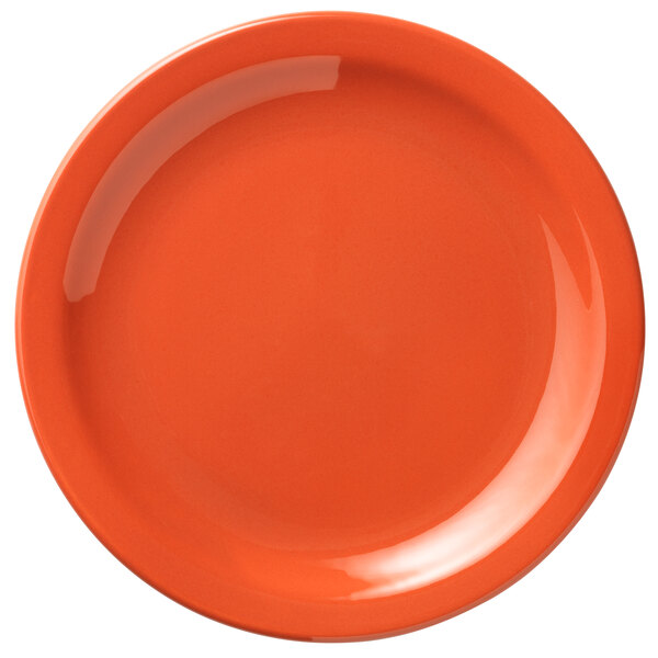 A close-up of a Libbey Cantina Cayenne porcelain plate with an orange border and white center.