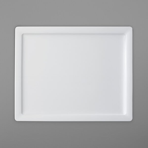 A white rectangular porcelain plate with a small square on it.