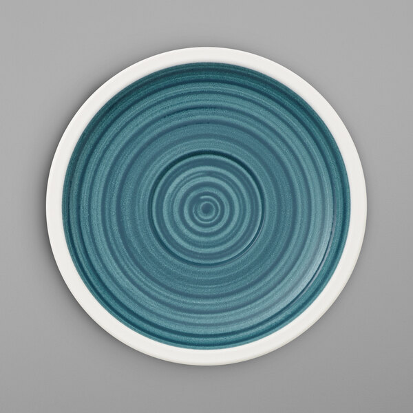 A Villeroy & Boch Artesano Ocean saucer in blue and white porcelain with a spiral design.