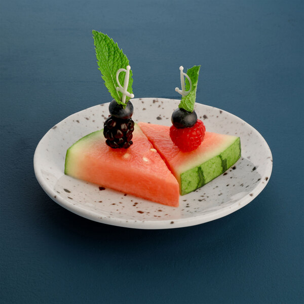 A plate of watermelon slices with berries.