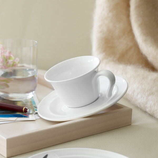 A white Villeroy & Boch Neufchatel cup on a saucer on a tray.