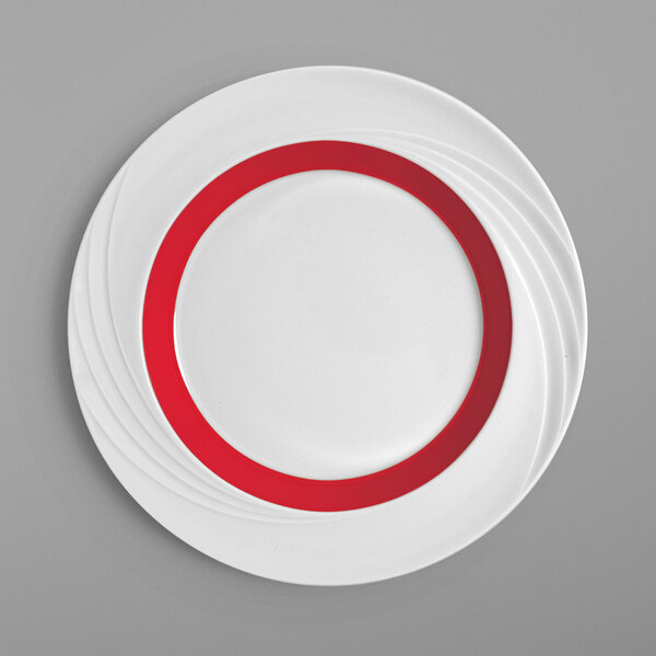 A white Schonwald porcelain plate with a red rim.