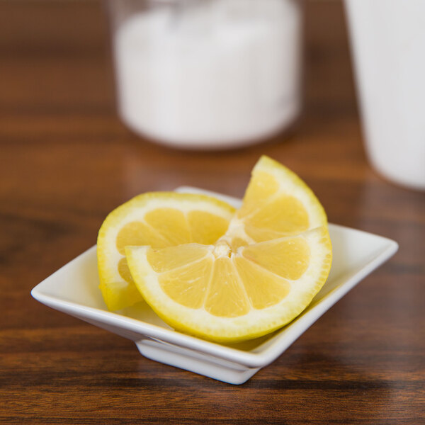 Lemon slices in a CAC Citysquare bright white square porcelain bowl.