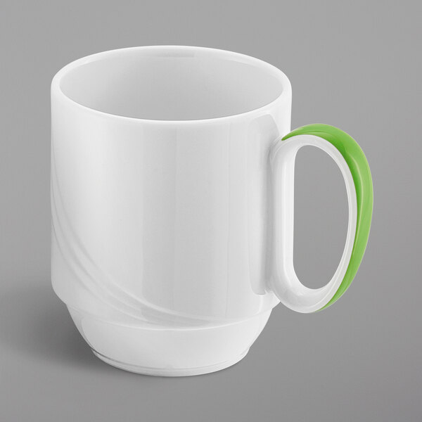 A white mug with a green handle.
