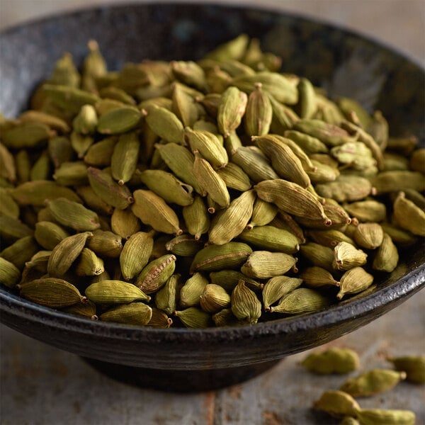 A bowl of Regal Whole Cardamom seeds.