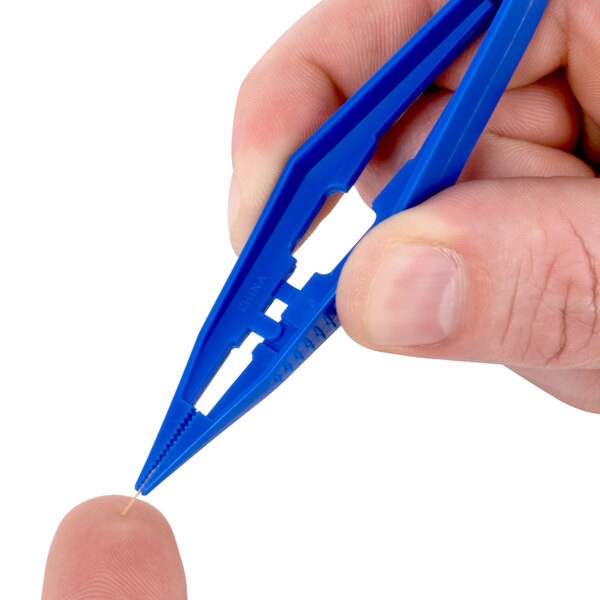 A hand holding a blue plastic Medi-First tweezers