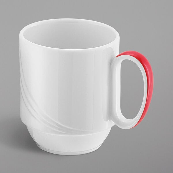 A white Schonwald porcelain mug with a red handle.
