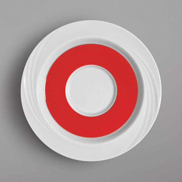 A white Schonwald porcelain saucer with a red circle on it.
