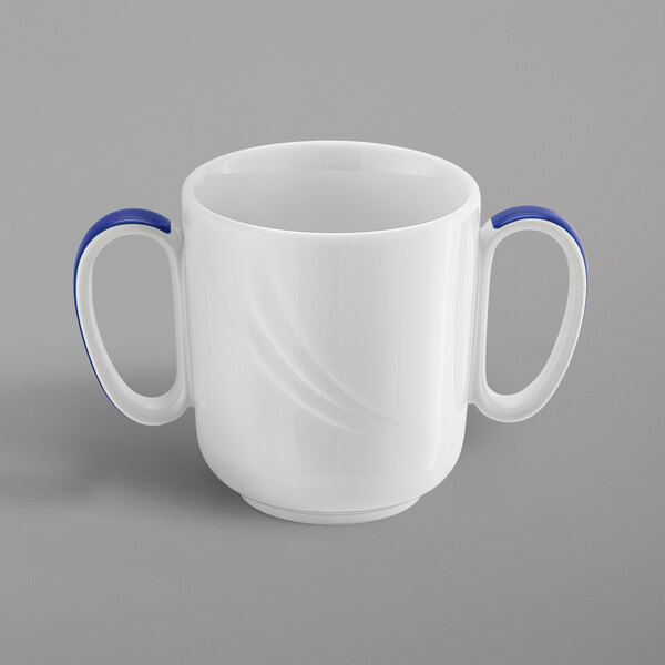 A white porcelain Schonwald mug with dark blue handles.