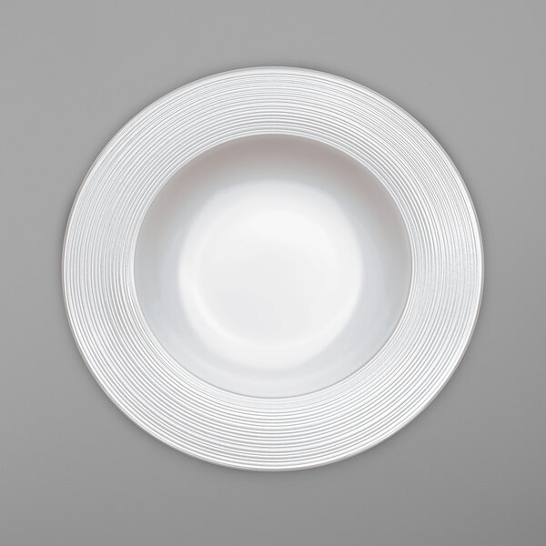 A Villeroy & Boch white bone porcelain plate with a circular swirl pattern.