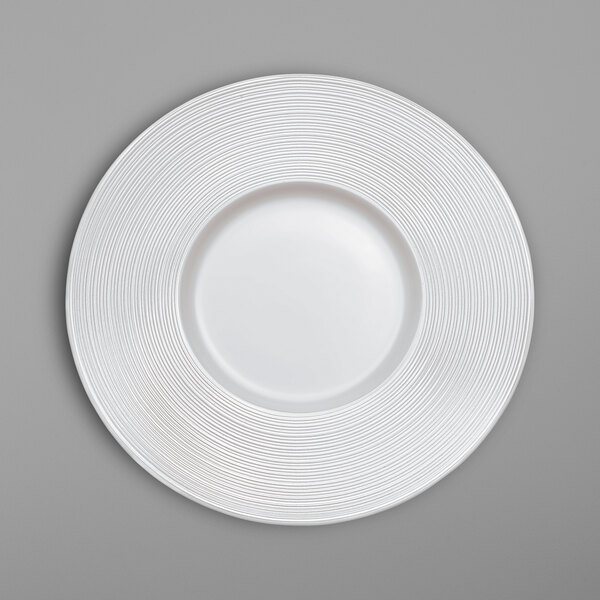 A white Villeroy & Boch bone porcelain plate with a spiral pattern.
