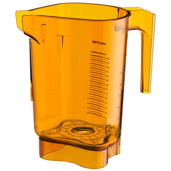 An orange Vitamix blender jar with a handle and measuring cup.