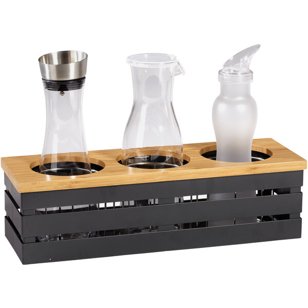 A GET Enterprises metal gray beverage display crate holding three clear glass containers.