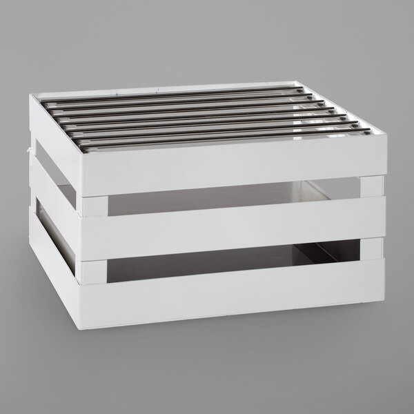 A white crate with metal slats on top.