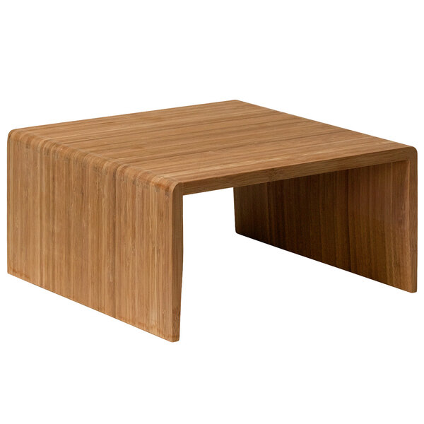 A square bamboo riser on a wooden table.