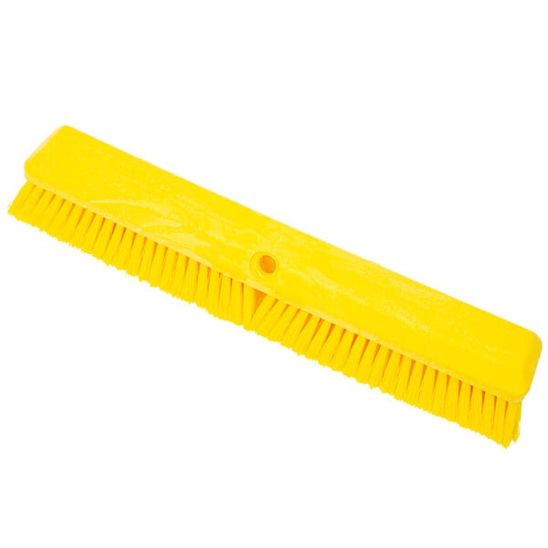 A Carlisle yellow push broom head with unflagged bristles.