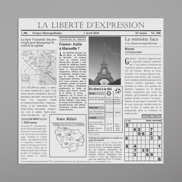 A white newsprint liner with French news on it, with a picture of the Eiffel Tower.