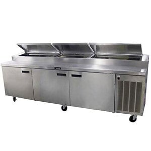 A Delfield stainless steel refrigerated pizza prep table with three doors.