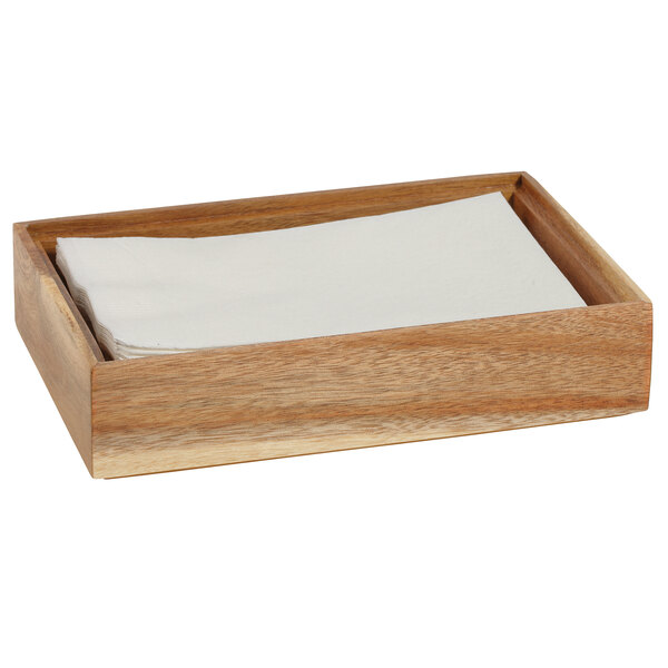 A wooden box with a stack of white napkins inside.