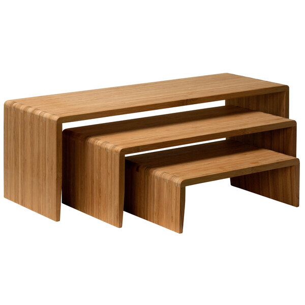 A wooden table with three bamboo risers on top.