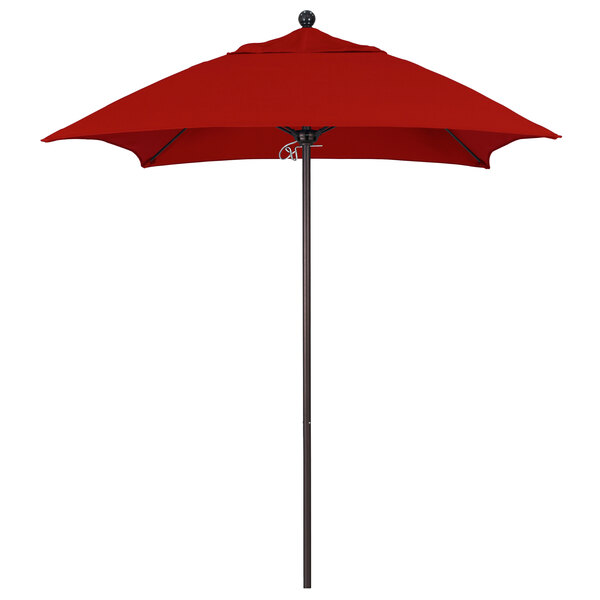A red California Umbrella on a bronze pole over a white background.