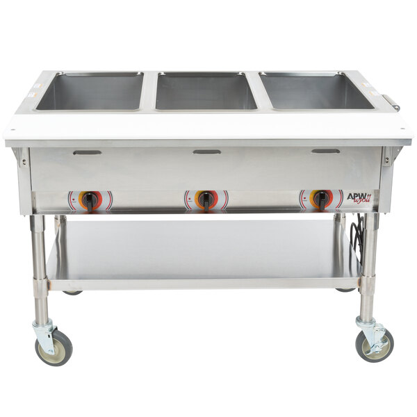 An APW Wyott stainless steel hot food warmer with three trays.