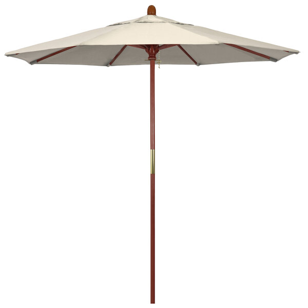 A close up of a California Umbrella with a white canopy and hardwood pole.
