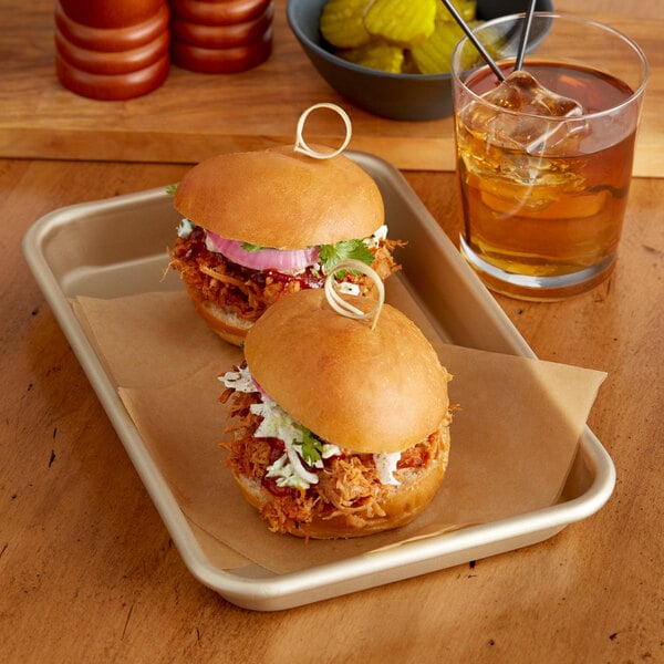 A Baker's Mark gold wire rim aluminum sheet tray with sliders, sandwiches, and a drink.