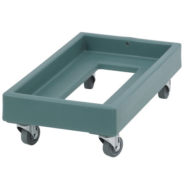 A grey plastic dolly with wheels for a Cambro milk crate.
