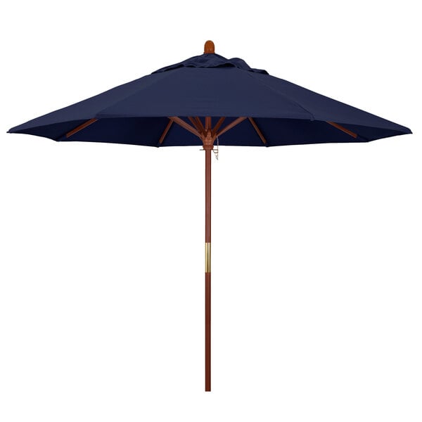 A California Umbrella round outdoor table umbrella with a navy blue Olefin canopy and hardwood pole.