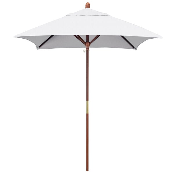 A white umbrella with a wooden pole and a wooden base.