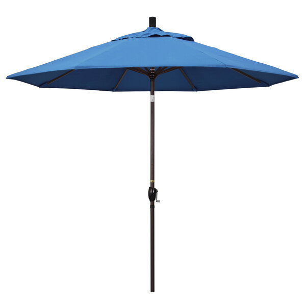 A close-up of a blue California Umbrella with a bronze aluminum pole.