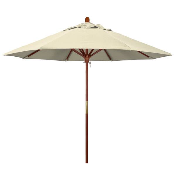 A close-up of a white California Umbrella with a brown pole.