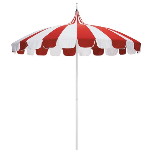 A California Umbrella with a natural and jockey red striped canopy and white pole.