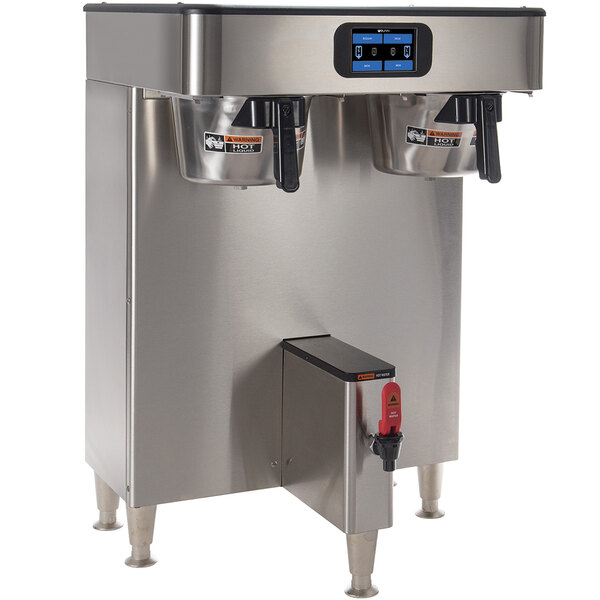 A Bunn stainless steel automatic coffee brewer on a school kitchen counter.