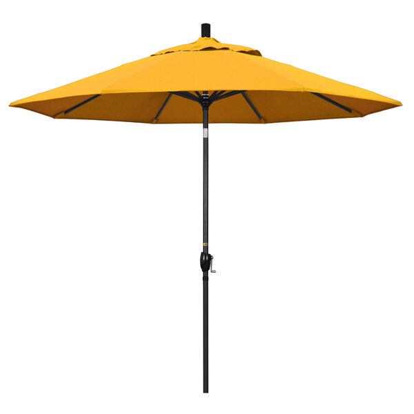 A close-up of a California Umbrella with a yellow canopy and black pole.
