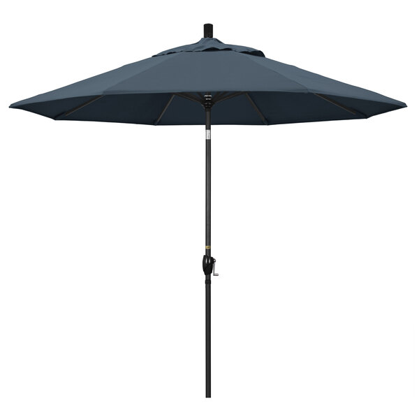 A California Umbrella with a sapphire blue canopy and stone black pole.