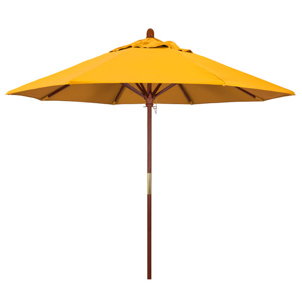 A close-up of a California Umbrella with a yellow Pacifica canopy on a hardwood pole.