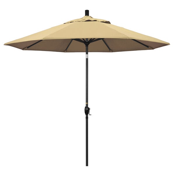 A beige California Umbrella on a stone black pole.