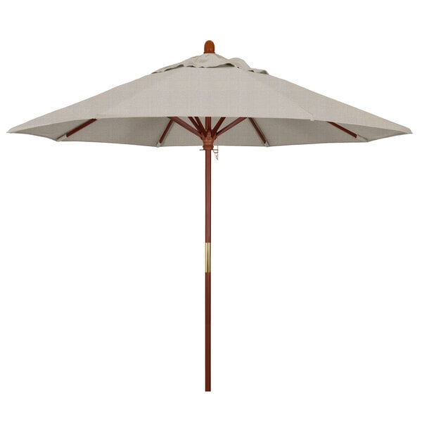 A California Umbrella Grove round outdoor umbrella with a white canopy and brown pole.
